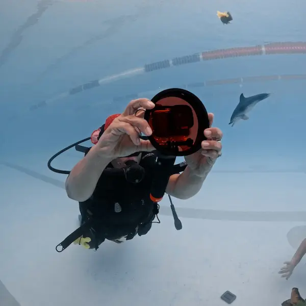 Alumno haciendo el curso de fotografía en pileta y fotografiando objetos